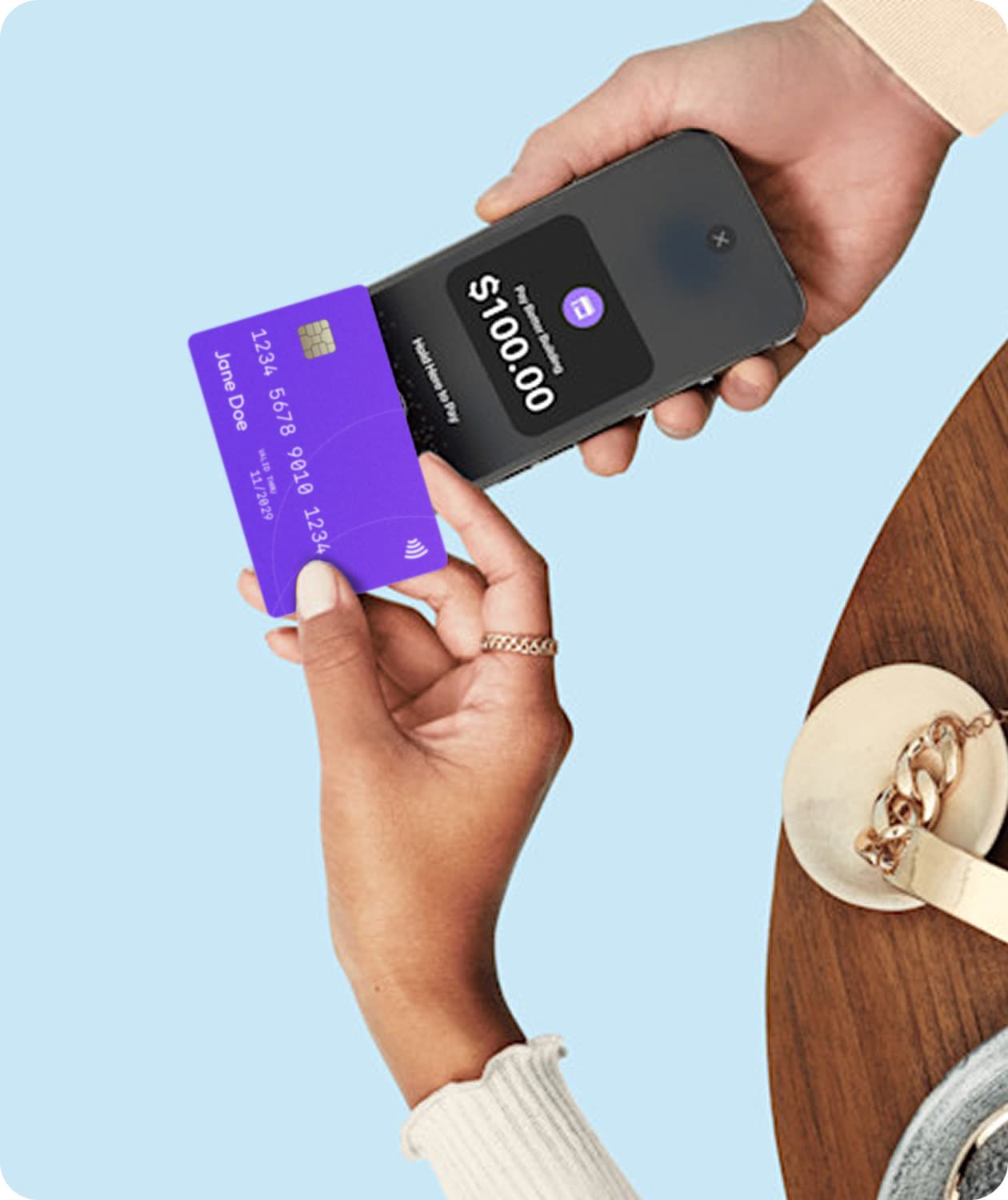 A customer holding a contactless card near an iPhone running Tap to Pay to complete a purchase